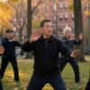 Group of adults practicing Tai Chi and Qigong outdoors in a Boston park